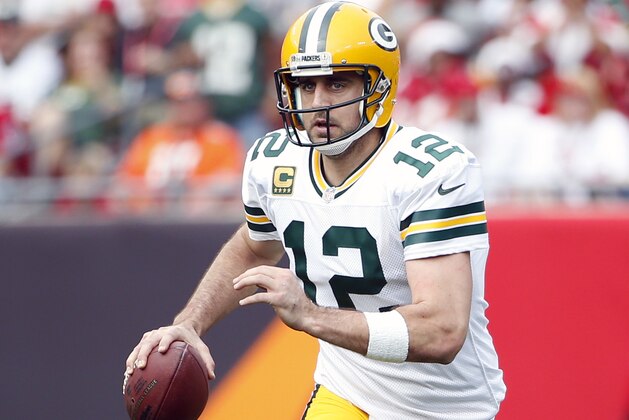 Green Bay Packers quarterback Aaron Rodgers (12) looks for an open receiver during an NFL football game against the Tampa Bay Buccaneers on Sunday, Dec. 21, 2014, in Tampa, Fla. (AP Photo/Brian Blanco)