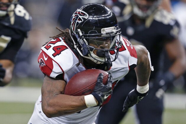 Atlanta Falcons running back Devonta Freeman (24) carries for a touchdown in the second half of an NFL football game against the New Orleans Saints in New Orleans, Sunday, Dec. 21, 2014. (AP Photo/Rogelio Solis)