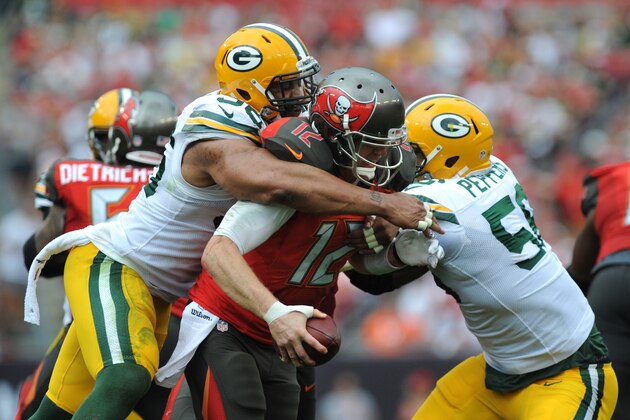 TAMPA, FL - DECEMBER 21: Defensive end Mike Neal #96 of the Green Bay Packers and outside linebacker outside linebacker Julius Peppers #56 of the Green Bay Packers sack quarterback Josh McCown #12 of the Tampa Bay Buccaneers in the third quarter at Raymond James Stadium on December 21, 2014 in Tampa, Florida. (Photo by Cliff McBride/Getty Images)