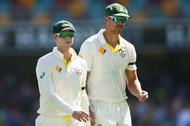 BRISBANE, AUSTRALIA - DECEMBER 17:  Australian captain Steve Smith talks to team mate Mitchell Johnson during day one of the 2nd Test match between Australia and India at The Gabba on December 17, 2014 in Brisbane, Australia.  (Photo by Cameron Spencer/Getty Images)