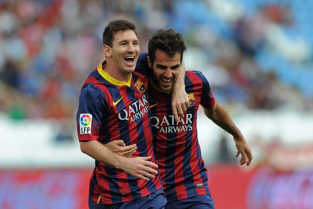 ALMERIA, SPAIN - SEPTEMBER 28:  Lionel Messi (L) celebrates with Cesc Fabregas after scoring FC Barcelona's opening goal during the La Liga match between UD Almeria and FC Barcelona on September 28, 2013 in Almeria, Spain.  (Photo by Denis Doyle/Getty Images)