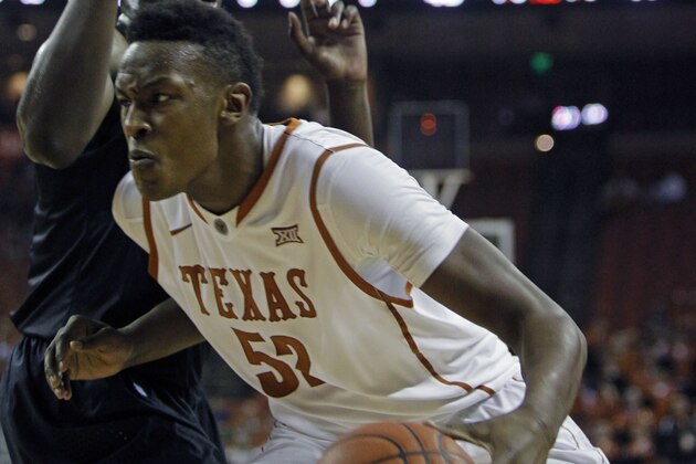 Texas forward Myles Turner (52) drives the ball against Long Beach State forward Temidayo Yussuf during an NCAA college basketball game, Saturday, Dec. 20, 2014, in Austin, Texas. (AP Photo/Michael Thomas)
