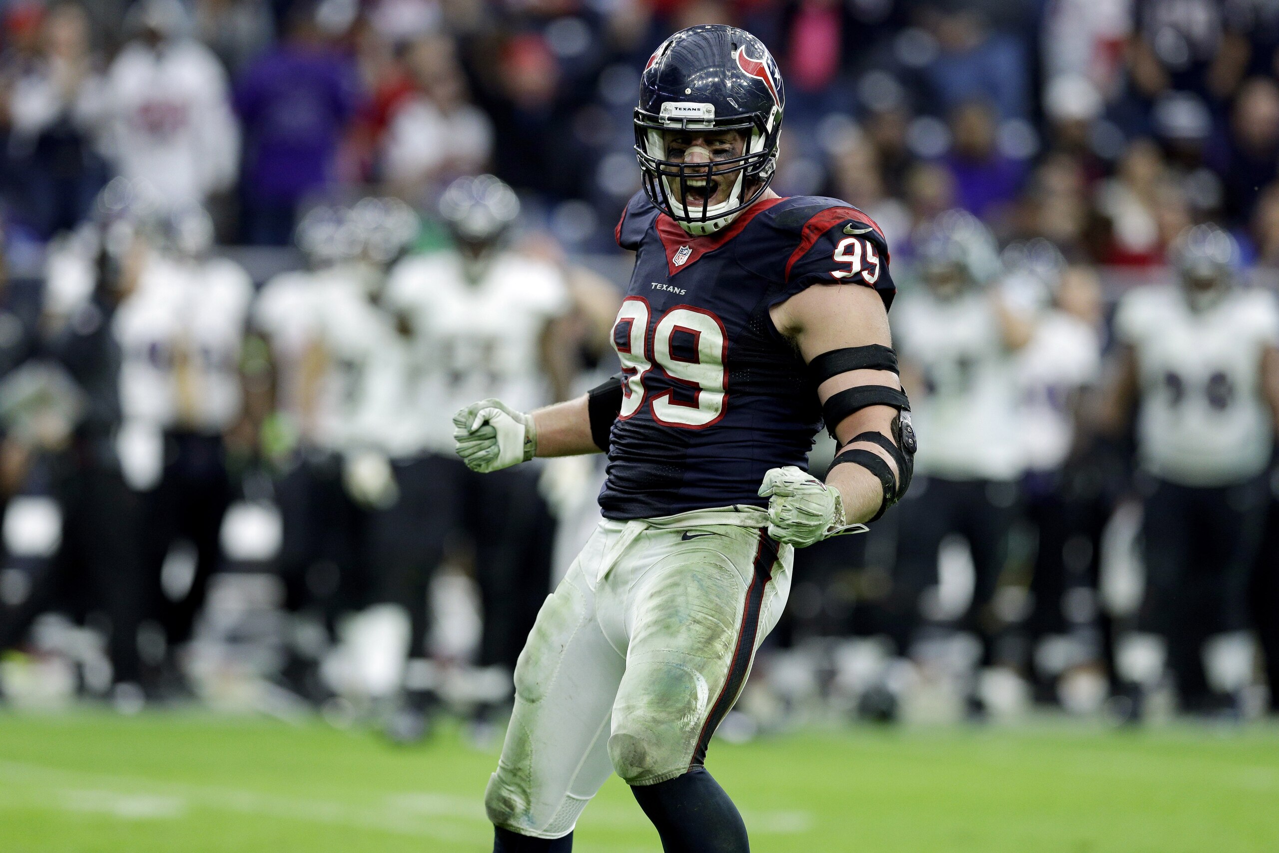Houston Texans defensive end J.J. Watt (99) celebrates after sacking Baltimore Ravens quarterback Joe Flacco during the second half of an NFL football game Sunday, Dec. 21, 2014, in Houston. (AP Photo/Patric Schneider)