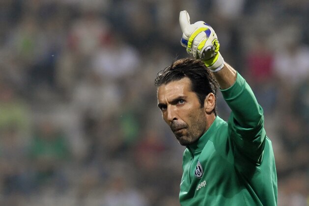 Juventus goalkeeper Gianluigi Buffon waves to supporters before a Serie A soccer match between Sassuolo and Juventus at Reggio Emilia's Mapei stadium, Italy, Saturday, Oct. 18, 2014. (AP Photo/Marco Vasini)