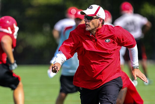 Georgia Bulldogs offensive coordinator Mike Bobo runs a drill during an NCAA college football practice at the University of Georgia in Athens, Ga., on Thursday, Aug. 2, 2012. (AP Photo/Daniel Shirey)