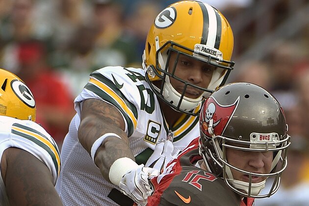 Tampa Bay Buccaneers quarterback Josh McCown (12) is sacked by Green Bay Packers strong safety Morgan Burnett (42) during the first quarter of an NFL football game Sunday, Dec. 21, 2014, in Tampa, Fla. (AP Photo/Phelan M. Ebenhack)