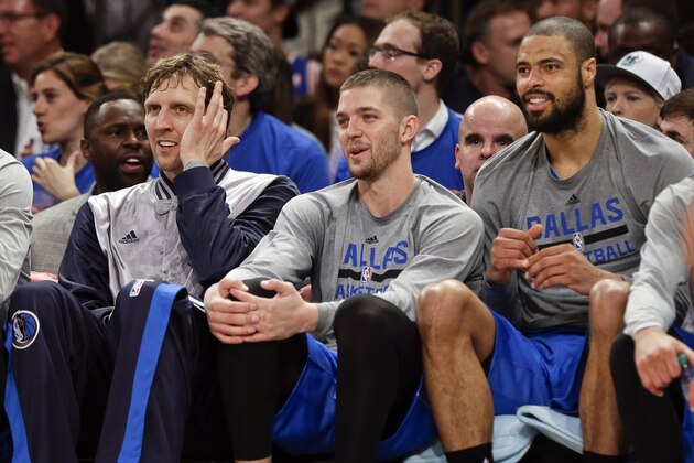 Dallas Mavericks' Dirk Nowitzki, left, Chandler Parsons, and Tyson Chandler, right, watch their team play during the second half of an NBA basketball game against the New York Knicks, Tuesday, Dec. 16, 2014, in New York. The Mavericks won 107-87. (AP Photo/Frank Franklin II)
