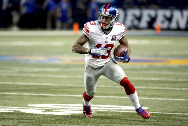 New York Giants wide receiver Odell Beckham Jr. runs with the ball after catching a pass for an 8-yard gain during the first half of an NFL football game against the St. Louis Rams Sunday, Dec. 21, 2014, in St. Louis. (AP Photo/Charlie Riedel)