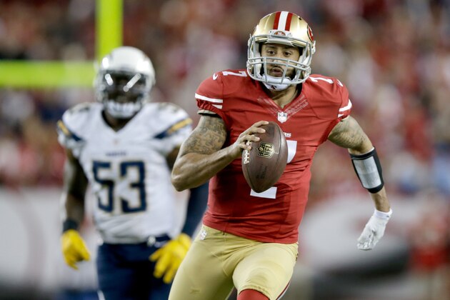 SANTA CLARA, CA - DECEMBER 20:  Quarterback Colin Kaepernick #7 of the San Francisco 49ers runs ahead of inside linebacker Kavell Conner #53 of the San Diego Chargers in the first half at Levi's Stadium on December 20, 2014 in Santa Clara, California.  (Photo by Ezra Shaw/Getty Images)
