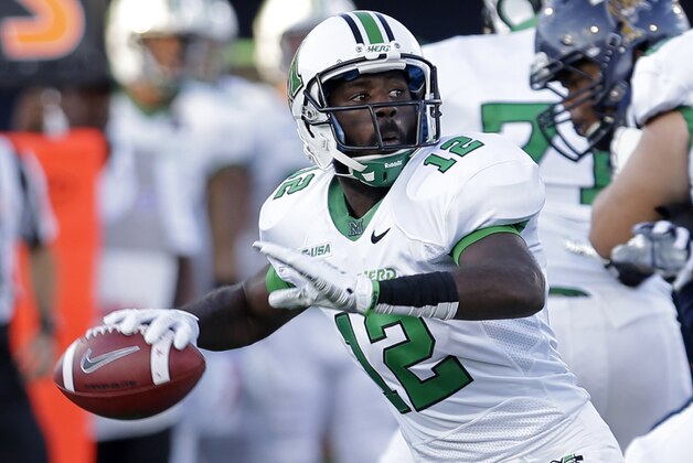 Marshall quarterback Rakeem Cato prepares to pass against Florida International during the first half of an NCAA college football game, Saturday, Oct. 18, 2014, in Miami. (AP Photo/Alan Diaz)