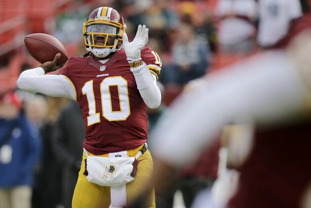 Washington Redskins quarterback Robert Griffin III (10) warms up before an NFL football game against the Philadelphia Eagles in Landover, Md., Saturday, Dec. 20, 2014. (AP Photo/Mark Tenally)