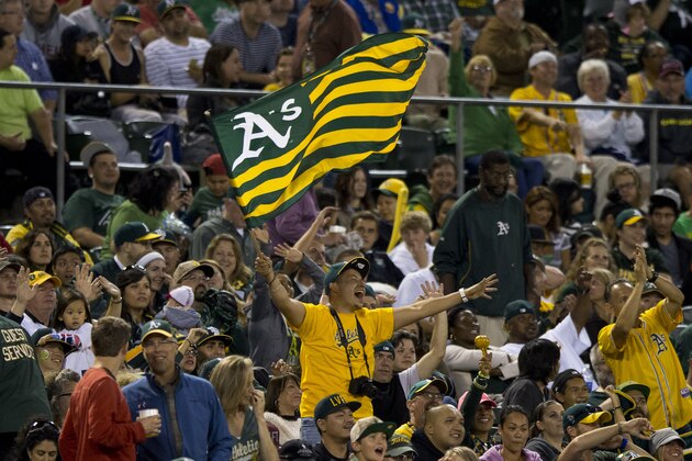 OAKLAND, CA - SEPTEMBER 23:  An Oakland Athletics fan waves a flag in the stands during the fifth inning against the Los Angeles Angels of Anaheim at O.co Coliseum on September 23, 2014 in Oakland, California. (Photo by Jason O. Watson/Getty Images)
