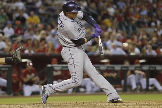 Colorado Rockies' Troy Tulowitzki hits against the  Arizona Diamondbacks during the second inning of a baseball game on Wednesday, April 30, 2014, in Phoenix. (AP Photo/Matt York)