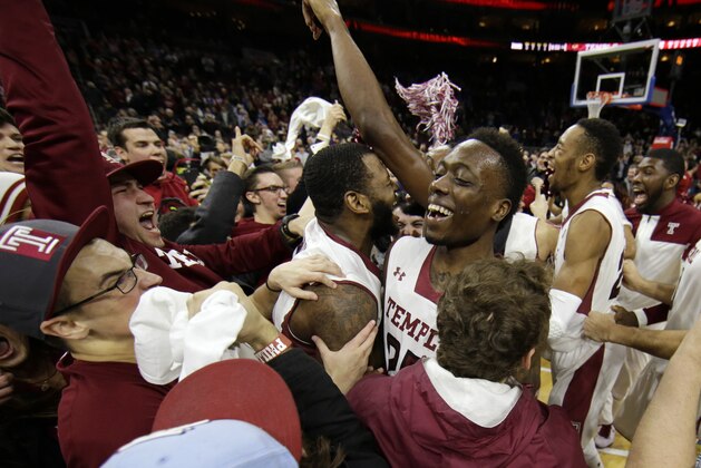 Temple players and fans celebrate after Temple won an NCAA college basketball game against Kansas, 77-52, Monday, Dec. 22, 2014, in Philadelphia. (AP Photo/Matt Slocum)