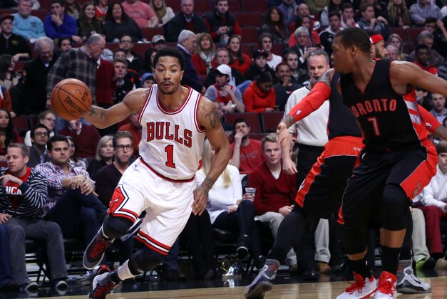 Dec 22, 2014; Chicago, IL, USA; Chicago Bulls guard Derrick Rose (1) drives past Toronto Raptors guard Kyle Lowry (7) during the first quarter of a game at the United Center. Mandatory Credit: Dennis Wierzbicki-USA TODAY Sports
