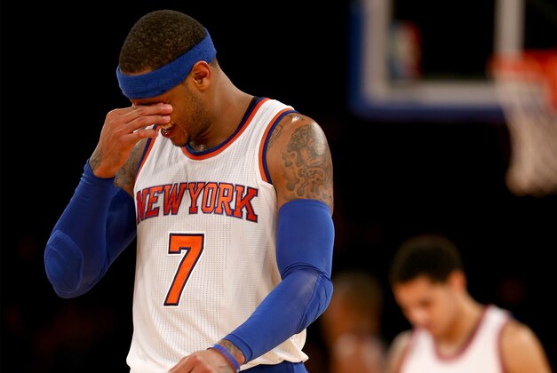 NEW YORK, NY - NOVEMBER 30:  Carmelo Anthony #7 of the New York Knicks reacts in the fourth quarter against the Miami Heat at Madison Square Garden on November 30, 2014 in New York City.The Miami Heat defeated the New York Knicks 86-79.NOTE TO USER: User expressly acknowledges and agrees that, by downloading and/or using this photograph, user is consenting to the terms and conditions of the Getty Images License Agreement.  (Photo by Elsa/Getty Images)