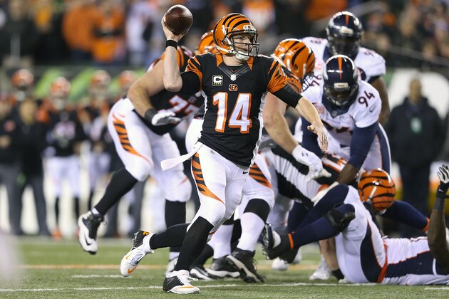 CINCINNATI, OH - DECEMBER 22:  Andy Dalton #14 of the Cincinnati Bengals fakes a pass while scrambling for a first down during the second quarter of the game against the Denver Broncos at Paul Brown Stadium on December 22, 2014 in Cincinnati, Ohio. (Photo by Andy Lyons/Getty Images)