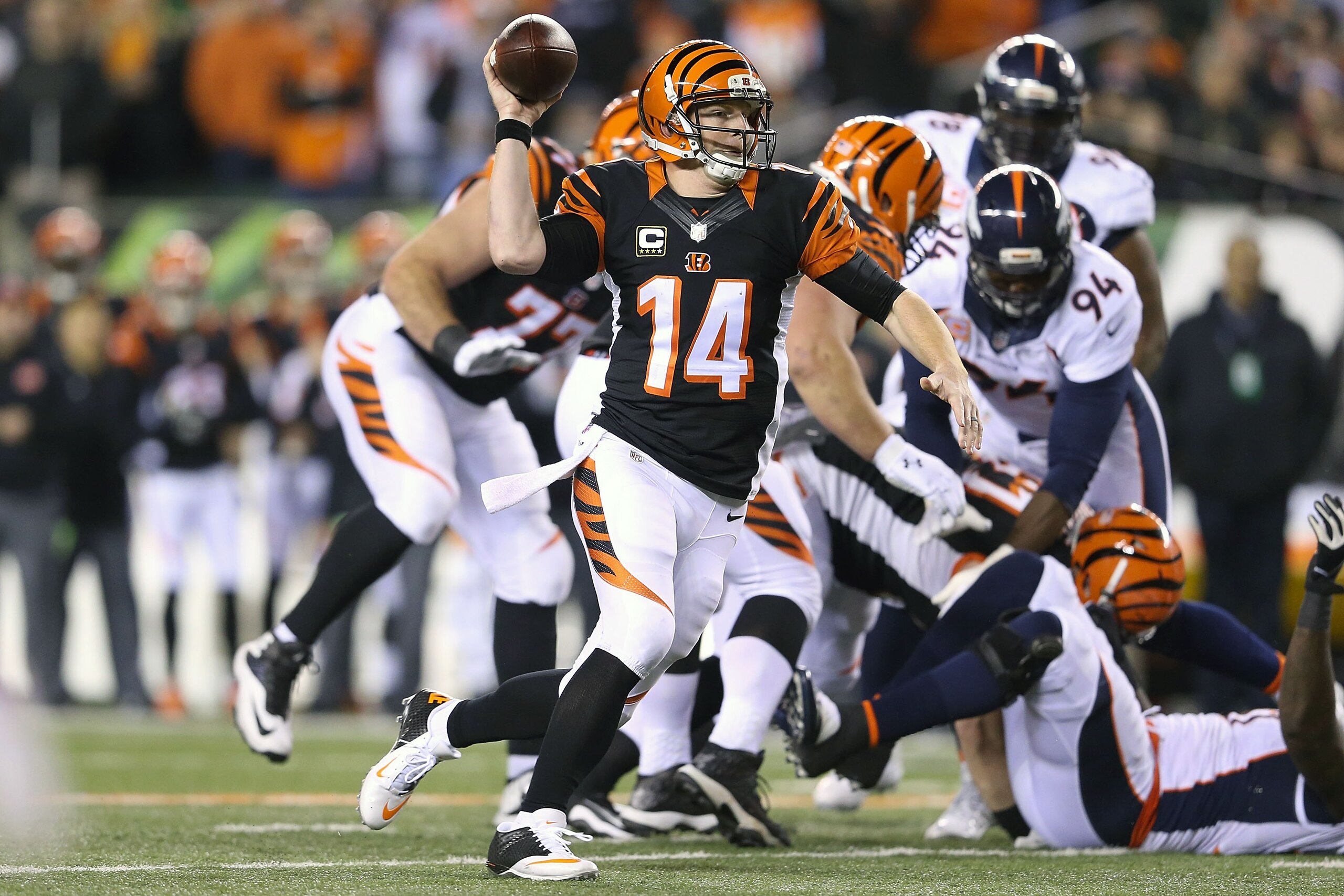 CINCINNATI, OH - DECEMBER 22:  Andy Dalton #14 of the Cincinnati Bengals fakes a pass while scrambling for a first down during the second quarter of the game against the Denver Broncos at Paul Brown Stadium on December 22, 2014 in Cincinnati, Ohio. (Photo by Andy Lyons/Getty Images)