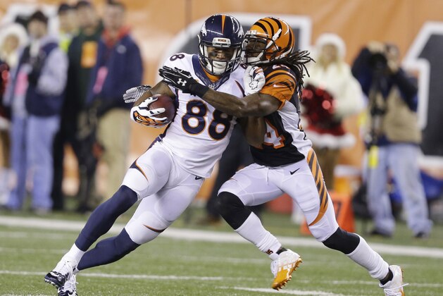 Cincinnati Bengals cornerback Adam Jones tackles Denver Broncos wide receiver Demaryius Thomas (88) during the second half of an NFL football game Monday, Dec. 22, 2014, in Cincinnati. (AP Photo/Michael Conroy)