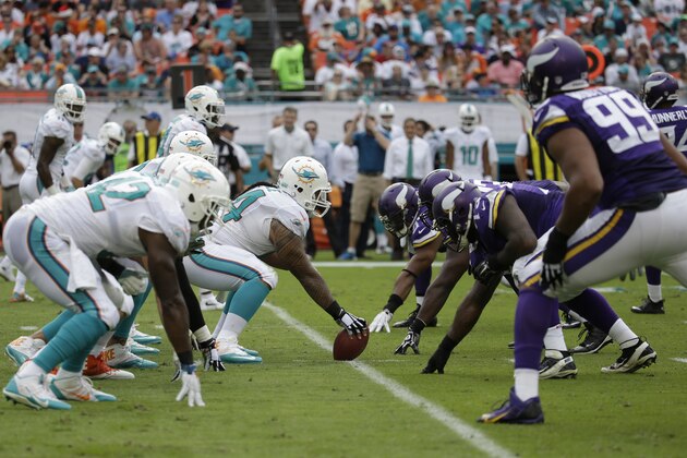 The Miami Dolphins and the Minnesota Vikings on the line of scrimmage during the first half of an NFL football game, Sunday, Dec. 21, 2014, in Miami Gardens, Fla. (AP Photo/Lynne Sladky)
