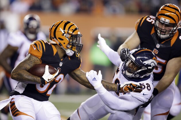 Cincinnati Bengals running back Jeremy Hill, left, runs past Denver Broncos outside linebacker Von Miller (58) during the first half of an NFL football game Monday, Dec. 22, 2014, in Cincinnati. (AP Photo/Darron Cummings)