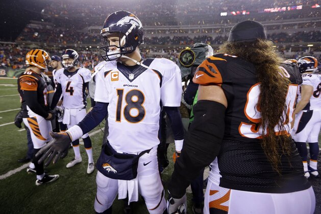 Denver Broncos quarterback Peyton Manning (18) comes off the field after an NFL football game against the Cincinnati Bengals Monday, Dec. 22, 2014, in Cincinnati. Cincinnati won 37-28. (AP Photo/Michael Conroy)