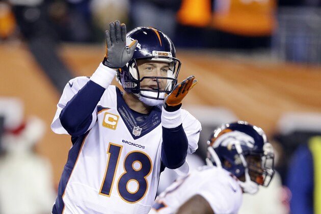 Denver Broncos quarterback Peyton Manning changes a play during the first half of an NFL football game against the Cincinnati Bengals Monday, Dec. 22, 2014, in Cincinnati. (AP Photo/Michael Conroy)