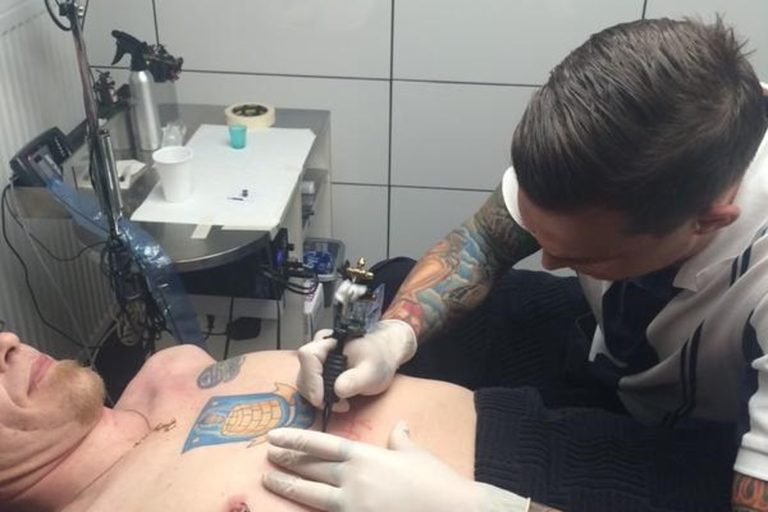 A fan of Denmark's Brondby IF gets a tattoo from star player Daniel Agger.