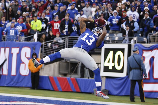 New York Giants wide receiver Odell Beckham (13) comes down with a pass in the end zone against the Washington Redskins during the fourth quarter of an NFL football game, Sunday, Dec. 14, 2014, in East Rutherford, N.J. A flag was called on the play and the catch was not ruled a touchdown. (AP Photo/Julio Cortez)