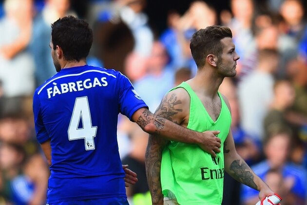 LONDON, ENGLAND - OCTOBER 05:  Cesc Fabregas of Chelsea consoles Jack Wilshere of Arsenal after the Barclays Premier League match between Chelsea and Arsenal at Stamford Bridge on October 4, 2014 in London, England.  (Photo by Shaun Botterill/Getty Images)