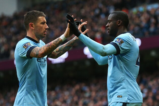 MANCHESTER, ENGLAND - DECEMBER 20: Yaya Toure (R) of Manchester City celebrates his goal with Aleksandar Kolarov of Manchester City during the Barclays Premier League match between Manchester City and Crystal Palace at Etihad Stadium on December 20, 2014 in Manchester, England.  (Photo by Alex Livesey/Getty Images)