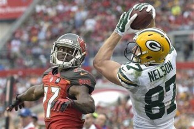 Green Bay Packers wide receiver Jordy Nelson (87) pulls in a 19-yard pass in front of Tampa Bay Buccaneers cornerback Johnthan Banks (27) during the fourth quarter of an NFL football game Sunday, Dec. 21, 2014, in Tampa, Fla. (AP Photo/Phelan M. Ebenhack)