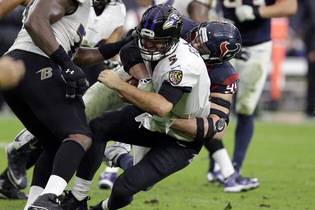 Houston Texans defensive end J.J. Watt (99) sacks Baltimore Ravens quarterback Joe Flacco (5) during the second half of an NFL football game Sunday, Dec. 21, 2014, in Houston. (AP Photo/Patric Schneider)