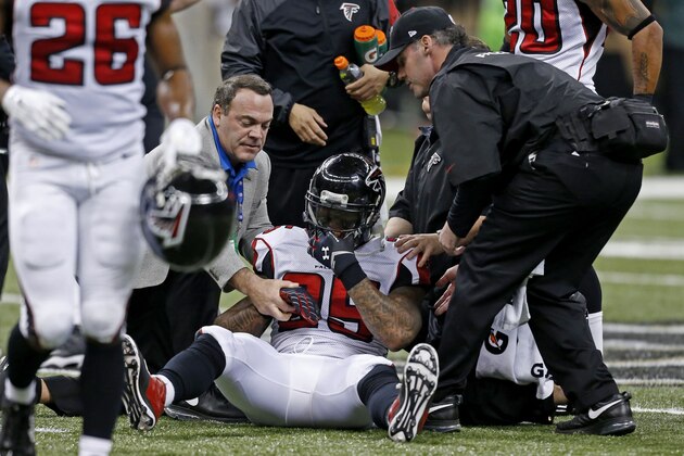 Atlanta Falcons strong safety William Moore (25) is helped off the field in the second half of an NFL football game against the New Orleans Saints in New Orleans, Sunday, Dec. 21, 2014. (AP Photo/Rogelio Solis)