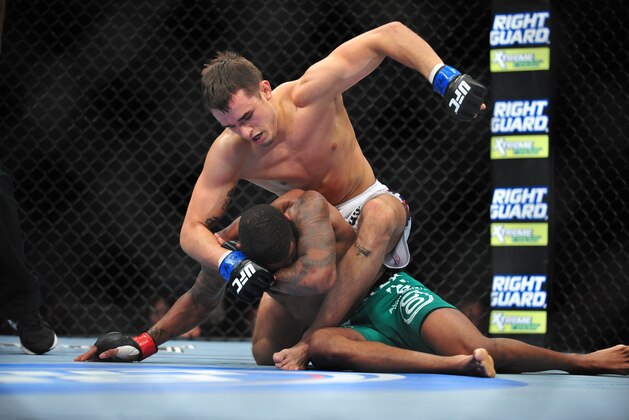 Dec 29, 2012; Las Vegas, NV, USA; Myles Jury (top) strikes Michael Johnson (bottom) during UFC 155 at the MGM Grand Garden Arena. Mandatory Credit: Gary A. Vasquez-USA TODAY Sports