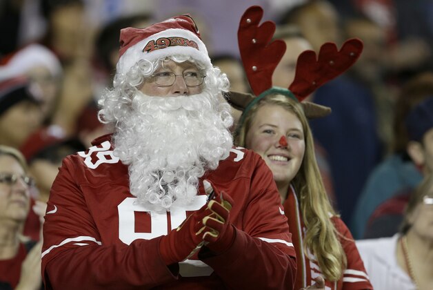 A San Francisco 49ers fan dressed as Santa Claus watches from his seat before an NFL football game between the San Francisco 49ers and the San Diego Chargers in Santa Clara, Calif., Saturday, Dec. 20, 2014. (AP Photo/Ben Margot)