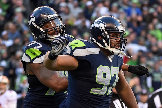SEATTLE, WA - DECEMBER 14: Defensive tackle Jordan Hill #97 of the Seattle Seahawks celebrates with defensive end Michael Bennett #72 of the Seattle Seahawks after making a sack during the third quarter of the game against the San Francisco 49ers at CenturyLink Field on December 14, 2014 in Seattle, Washington.  (Photo by Steve Dykes/Getty Images)