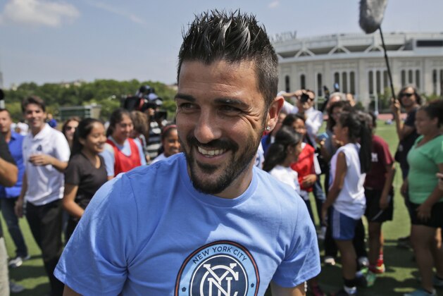 FILE - In this July 31, 2014 file photo, David Villa plays soccer with kids from the South Bronx United program in front of Yankee Stadium in New York. The A-League kicks off its 10th season with a new star attraction - Spanish striker David Villa for a 10-match stint - while some of the marquee men of the last several seasons, including Alessandro Del Piero, are gone. (AP Photo/Seth Wenig, File)