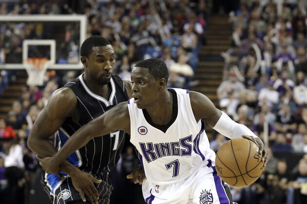 Sacramento Kings guard Darren Collison, right, dribbles past Orlando Magic guard Ben Gordon during the fourth quarter of an NBA basketball game in Sacramento, Calif., Saturday, Dec. 6, 2014. The Magic Won 105-96. (AP Photo/Rich Pedroncelli)