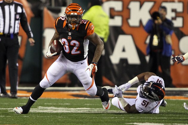 CINCINNATI, OH - DECEMBER 22:  Jeremy Hill #32 of the Cincinnati Bengals breaks a tackle by Todd Davis #51 of the Denver Broncos and runs the ball 85 yards for a touchdown during the first quarter at Paul Brown Stadium on December 22, 2014 in Cincinnati, Ohio. (Photo by John Grieshop/Getty Images)