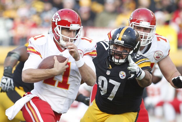 Dec 21, 2014; Pittsburgh, PA, USA; Kansas City Chiefs quarterback Alex Smith (11) rushes the ball as Pittsburgh Steelers defensive end Cameron Heyward (97) defends during the third quarter at Heinz Field. The Steelers won 20-12. Mandatory Credit: Charles LeClaire-USA TODAY Sports