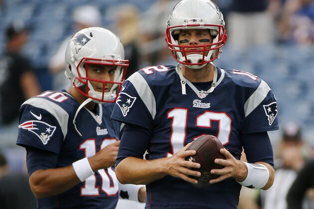New England Patriots quarterbacks Jimmy Garoppolo (10) and Tom Brady (12) pause during warm-up's before an NFL football game Sunday, Sept. 21, 2014, in Foxborough, Mass. (AP Photo/Elise Amendola)