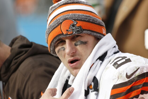 Cleveland Browns' Johnny Manziel (2) on the bench during the second half of an NFL football game against the Carolina Panthers in Charlotte, N.C., Sunday, Dec. 21, 2014. The Panthers won 17-13. (AP Photo/Bob Leverone)