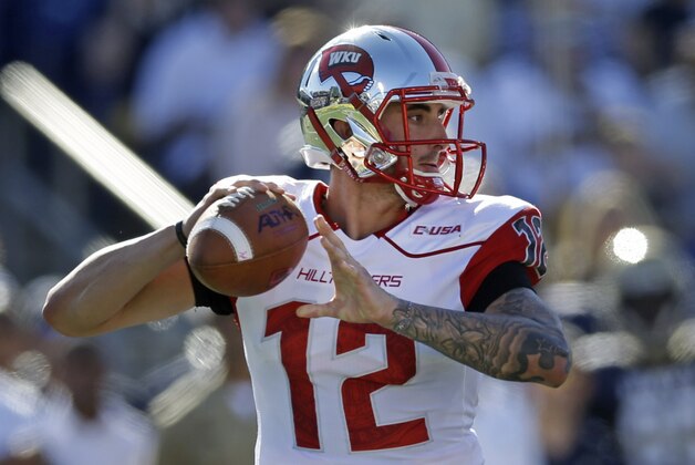 Western Kentucky quarterback Brandon Doughty throws to a receiver in the first half of an NCAA college football game against Navy in Annapolis, Md., Saturday, Sept. 27, 2014. (AP Photo/Patrick Semansky)
