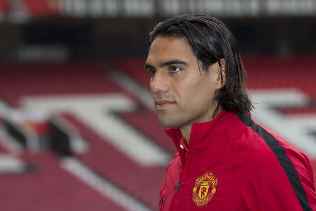 Manchester United's new player Radamel Falcao walks across the pitch at Old Trafford Stadium, Manchester, England, Thursday Sept. 11, 2014. The Colombian striker Falcao joined on a season-long loan deal from Ligue 1 side Monaco as Louis van Gaal looks to bolster his attacking options. (AP Photo/Jon Super)