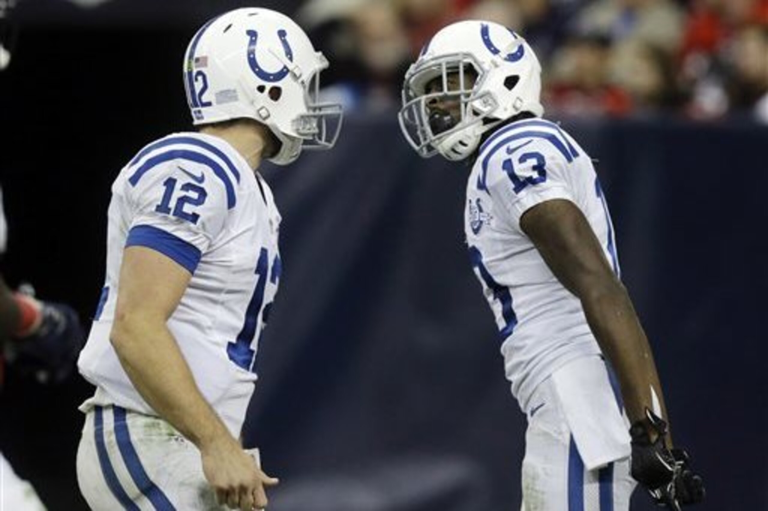 CORRECTS FIRST NAME FROM T.J. YATES TO T.Y. HILTON  - Indianapolis Colts' Andrew Luck (12) and T.Y. Hilton (13) celebrate after they connected for a touchdown against the Houston Texans during the fourth quarter of an NFL football game Sunday, Nov. 3, 2013, in Houston. (AP Photo/Patric Schneider)
