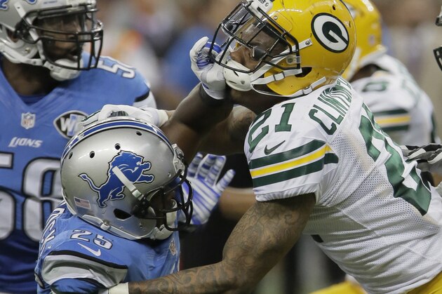 Green Bay Packers free safety Ha Ha Clinton-Dix (21) gets a hand to his face from Detroit Lions running back Theo Riddick (25) during the second half of an NFL football game in Detroit, Sunday, Sept. 21, 2014. (AP Photo/Duane Burleson)