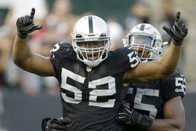 Oakland Raiders outside linebacker Khalil Mack (52) celebrates after sacking San Francisco 49ers quarterback Colin Kaepernick with outside linebacker Sio Moore during the fourth quarter of an NFL football game in Oakland, Calif., Sunday, Dec. 7, 2014. The Raiders won 24-13. (AP Photo/Ben Margot)