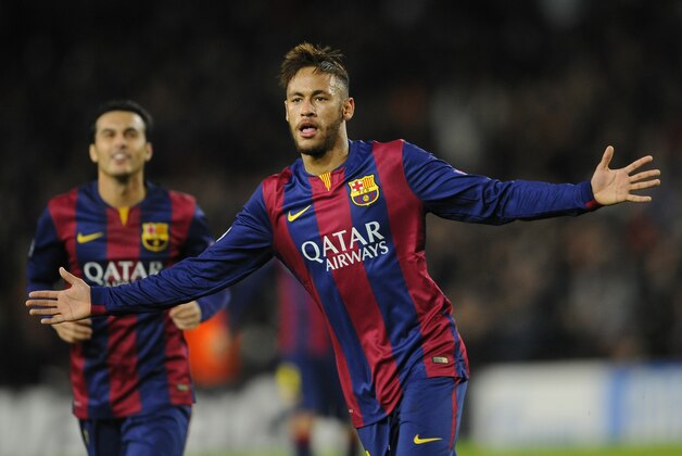 Barcelona's Neymar, right, celebrates his side's 2nd goal during the Group F Champions League soccer match between FC Barcelona and PSG at the Camp Nou stadium in Barcelona, Spain, Wednesday Dec. 10, 2014. (AP Photo/Manu Fernandez)