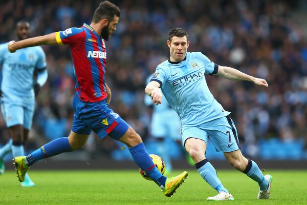 MANCHESTER, ENGLAND - DECEMBER 20: James Milner of Manchester City is challenged by Joe Ledley of Crystal Palace during the Barclays Premier League match between Manchester City and Crystal Palace at Etihad Stadium on December 20, 2014 in Manchester, England.  (Photo by Michael Steele/Getty Images)